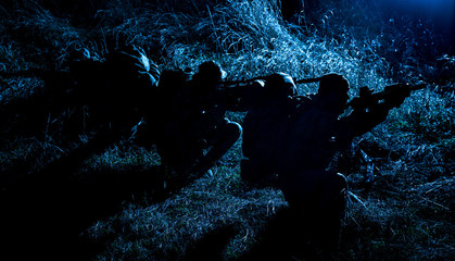Army tactical group fighters sneaking in darkness