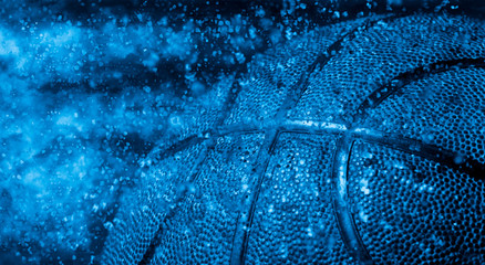 Closeup detail of basketball ball texture background. Blue filter © Augustas Cetkauskas