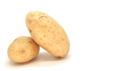 Young white potato, top view. Isolated potatoes on a white background.  Fresh food for vegetarians. Raw vegetable, root vegetable. Photo harvesting potatoes for a designer.
