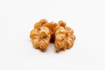 One peeled walnut on a white background.