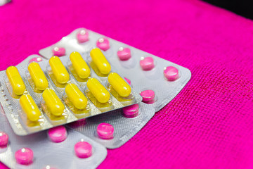 multicolored pills and antibiotics, the concept of drug treatment and pharmaceuticals. Treatment at...