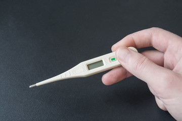 electronic thermometer on a black background