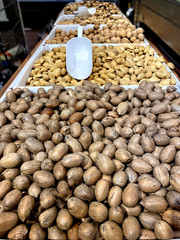 Long view of piles of nuts in shells 