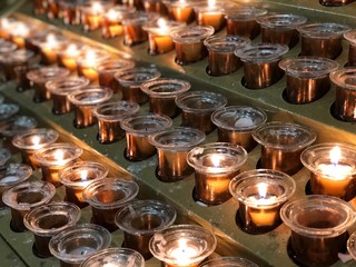 Many burning candles with shallow of field.Church of Duomo  di Milano 