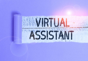 Writing note showing Virtual Assistant. Business concept for demonstrating who provides various services to entrepreneurs Cardboard which is torn placed above a wooden classic table