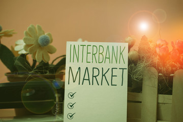 Writing note showing Interbank Market. Business concept for forex market where banks exchange...