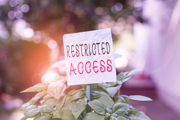 Word writing text Restricted Access. Business photo showcasing A class of service in which users may be denied access Plain empty paper attached to a stick and placed in the green leafy plants