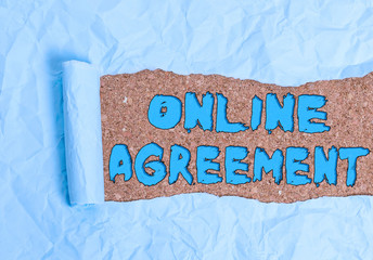 Word writing text Online Agreement. Business photo showcasing contract modelled signed and executed electronically Cardboard which is torn in the middle placed above a wooden classic table