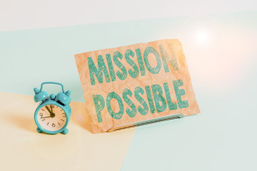 Text sign showing Mission Possible. Business photo text special assignment that is given to a demonstrating or group Mini size alarm clock beside a Paper sheet placed tilted on pastel backdrop