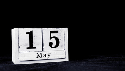 May 15th, Fifteenth of May, Day 15 of month May - vintage wooden white calendar blocks on black background with empty space for text