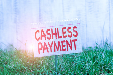 Conceptual hand writing showing Cashless Payment. Concept meaning transaction will be through electronic media or credit card Mathematic paper attached to a stick and placed in the grassy land