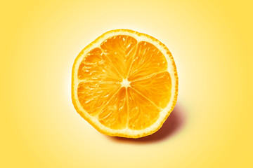 Lemon slice on a light yellow background