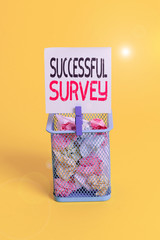 Conceptual hand writing showing Successful Survey. Concept meaning measure of opinions or experiences of a group of showing Trash bin crumpled paper clothespin office supplies yellow