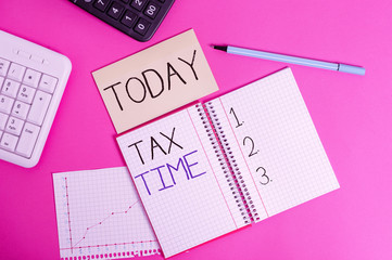 Handwriting text Tax Time. Conceptual photo compulsory contribution state revenue levied government on workers Writing equipments and computer stuffs placed above classic wooden table