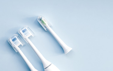 Electric toothbrush on blue background.