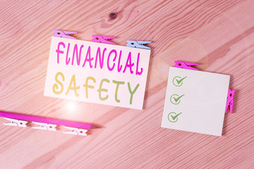 Word writing text Financial Safety. Business photo showcasing enough money saved to cover emergencies and financial goals Colored clothespin papers empty reminder wooden floor background office
