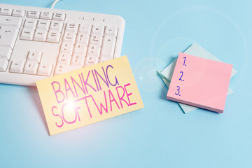 Text sign showing Banking Software. Business photo text typically refers to core banking software and interfaces Paper blue desk computer keyboard office study notebook chart numbers memo