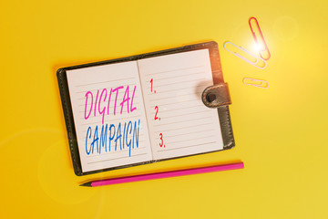 Conceptual hand writing showing Digital Campaign. Concept meaning effort put forward by a company to drive engagement Dark leather locked diary striped sheets marker colored background