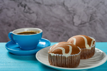 side view chocolate flavor cup cakes and cup of coffee