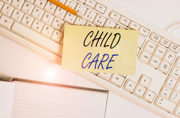 Word writing text Child Care. Business photo showcasing a care of children especially as a service while parents at work White pc keyboard with empty note paper and paper clips above white background