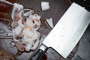 Fototapeta na wymiar fresh raw squids being cut in pieces