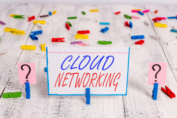 Conceptual hand writing showing Cloud Networking. Concept meaning sourcing and utilization of one or more network resources Crumbling sheet with paper clips placed on the wooden table