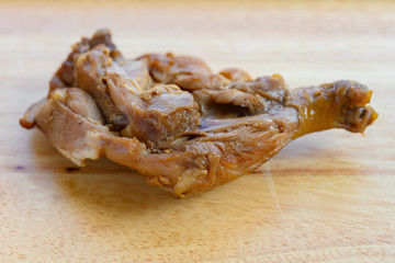 side view fresh chicken leg on wood backgorund
