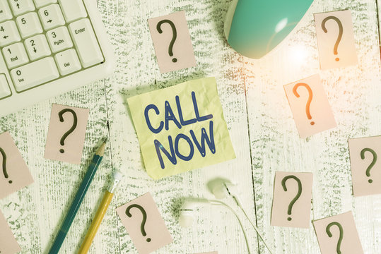 Word writing text Call Now. Business photo showcasing To immediately contact a demonstrating using telecom devices with accuracy Writing tools, computer stuff and scribbled paper on top of wooden