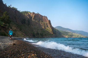 Fototapeta premium A girl walks along the shore of Lake Baikal