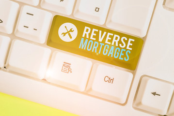 Writing note showing Reverse Mortgages. Business concept for borrower to access the unencumbered...