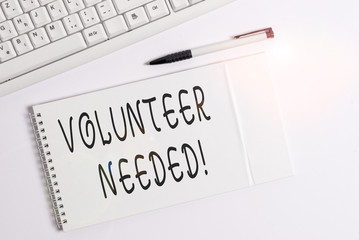 Conceptual hand writing showing Volunteer Needed. Concept meaning need work for organization without being paid White pc keyboard with note paper above white background