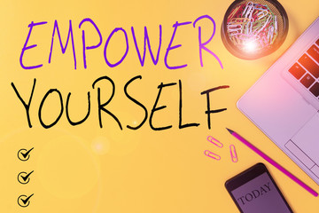 Text sign showing Empower Yourself. Business photo showcasing giving you the power to take control of your own destiny Slim trendy laptop pencil smartphone clips container colored background