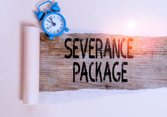 Text sign showing Severance Package. Business photo showcasing pay and benefits employees receive when leaving employment Alarm clock and torn cardboard placed above a wooden classic table backdrop