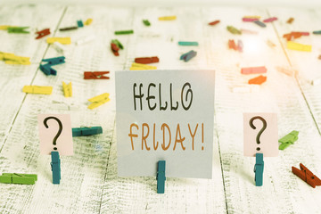 Writing note showing Hello Friday. Business concept for you say this for wishing and hoping another good lovely week Crumbling sheet with paper clips placed on the wooden table