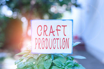 Writing note showing Craft Production. Business concept for process of analysisufacturing without the aid of tool or by hand Plain paper attached to stick and placed in the grassy land