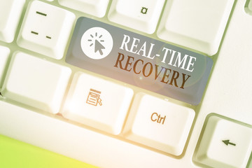 Writing note showing Real Time Recovery. Business concept for maximum time period in which recent...
