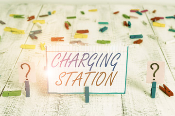 Conceptual hand writing showing Charging Station. Concept meaning places where showing charge their electric equipment Crumbling sheet with paper clips placed on the wooden table