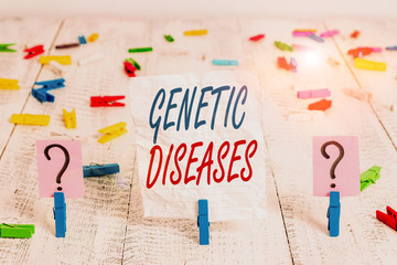 Handwriting text Genetic Diseases. Conceptual photo disease caused by an abnormality in an individual s is genome Scribbled and crumbling sheet with paper clips placed on the wooden table