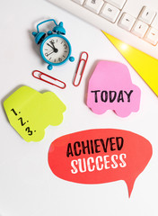 Writing note showing Achieved Success. Business concept for the achievement of desired visions and planned goals Flat lay with copy space on bubble paper clock and paper clips