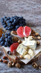 Fototapeta na wymiar Blue cheese with nuts and fruits. Cheese appetizer. Keto diet. Keto Set
