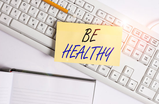 Word writing text Be Healthy. Business photo showcasing to be vigorous and totally free from bodily or mental diseases White pc keyboard with empty note paper and paper clips above white background