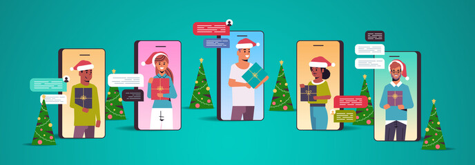 people in santa hats using chatting app social network chat bubble communication concept mix race men women in smartphone screens holding gift boxes online mobile application portrait vector