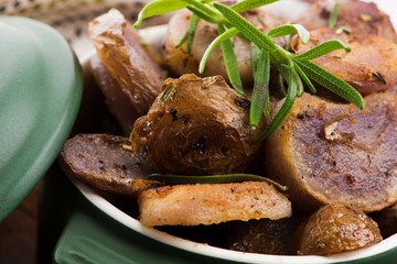 Fired violet potato slices with herbs, close view