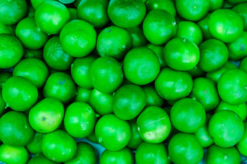 Organic pile of green Limes on a local farmer market.