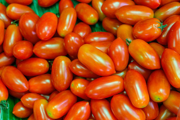 Queen tomatoes stacked in a tray in the fresh market