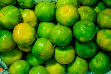 Fresh oranges are piled up in the fresh market.