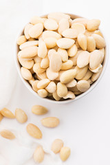 Bowl of almonds on a white background