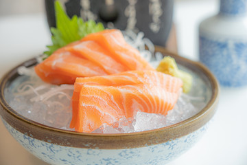 Fress fresh traditional Japanese healthy food name’s sashimi salmon served on ice in a bowl in a Japaneses restaurant..