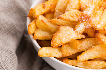 Bowl of potatoe fries on a white background