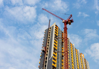 Fototapeta premium Tower crane and construction of a new building with sky background.